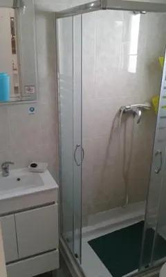 a bathroom with a shower and a sink at Villa Quica, heated pool in Albufeira
