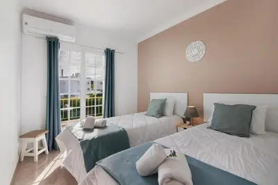 a bedroom with a large bed and a window at Villa Martinique in Albufeira
