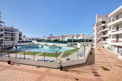 a large swimming pool in front of some buildings at Apartamento Sousa e Filhos in Albufeira