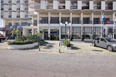 a car parked in front of a building at Apartamento Sousa e Filhos in Albufeira