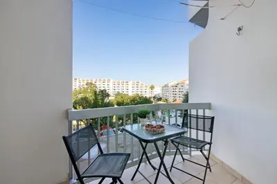 a table and chairs on a balcony with a view at Apartamento Sousa e Filhos in Albufeira
