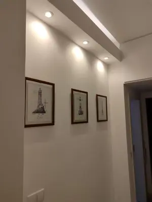 a wall with three pictures of the eiffel tower at Peixe and Barco Studio's in Vilamoura