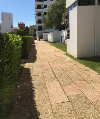 a sidewalk in front of a building at Peixe and Barco Studio's in Vilamoura