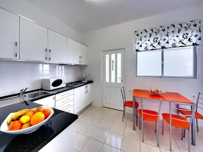 a kitchen with a bowl of fruit on a counter at Inn The Beach Apartments by Seareen in Albufeira