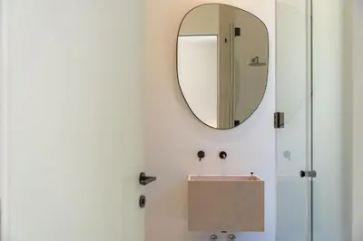 a bathroom with a mirror and a sink at Luxury Villa In Quinta do Lago Private pool Rooftop Jacuzzi Office Game room ARKEO LUXURY in Almancil