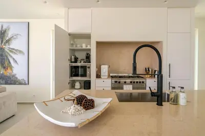 a large kitchen with a table in a room at Modern Sea View Villa, Heated Pool,Rooftop Jacuzzi Outdoor Kitchen 12min faro Airport in Santa Bárbara de Nexe