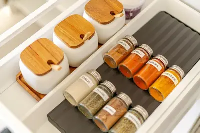 a drawer filled with lots of jars of spices at Modern Sea View Villa, Heated Pool,Rooftop Jacuzzi Outdoor Kitchen 12min faro Airport in Santa Bárbara de Nexe