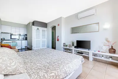 a bedroom with a bed and a flat screen tv at Studio avec vue mer et piscine Algarve Portugal in Albufeira