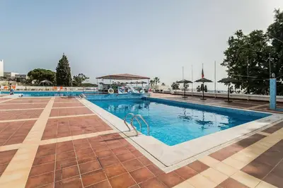 a large swimming pool with blue water at Studio avec vue mer et piscine Algarve Portugal in Albufeira