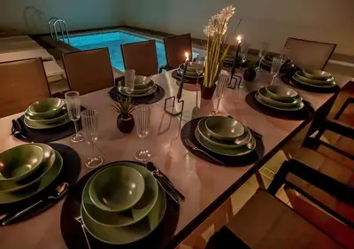 a dining room table with plates and glasses on it at Villa MariVital I Luxury I Heated Pool I Old Town in Albufeira