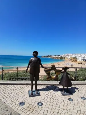 a beach with a lot of people and the ocean at Villa Martina in Albufeira
