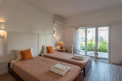a bedroom with two beds and a large window at LovelyStay - Green Oasis Villa in Vilamoura