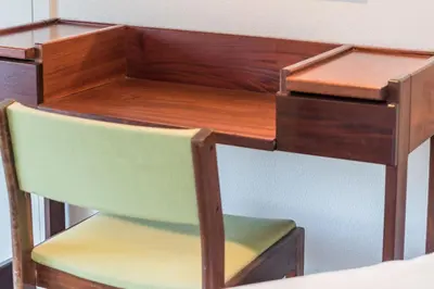 a wooden desk with a green chair underneath it at LovelyStay - Green Oasis Villa in Vilamoura