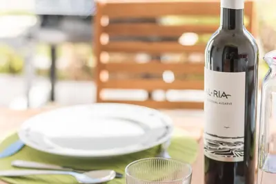 a bottle of wine and a glass on a table at LovelyStay - Green Oasis Villa in Vilamoura