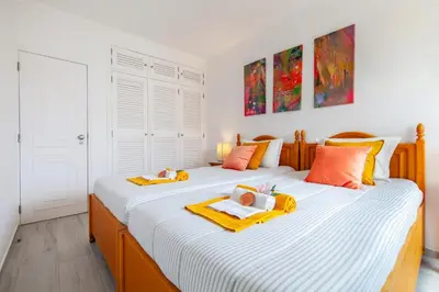 a table with plates of food and a bowl of fruit at Apartment Portofino 2 by Algarve Vacation in Quarteira