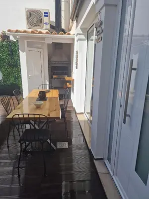 a patio with chairs and tables in a building at RECANTO da FELICIDADE in Albufeira