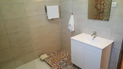 a bathroom with a toilet and a sink at Villa V4 Filomena in Mosqueira