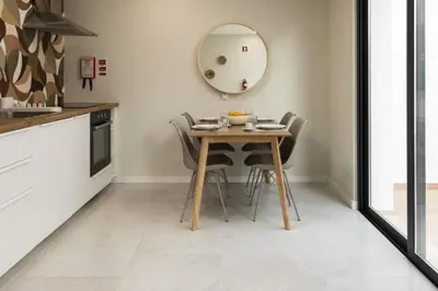 a living room with a television on a white cabinet at Villa 41 - Private Studios Faro Airport, Beach and City Center in Faro