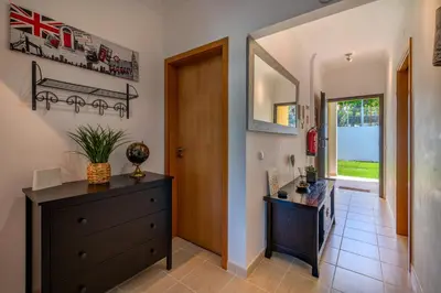 a hallway with a dresser and a mirror at Apart Encosta S Jose - Piscina - Estacionamento in Guia