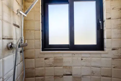 a bathroom with a shower and a window at Casa dos Sonhos, Vale do Lobo in Almancil
