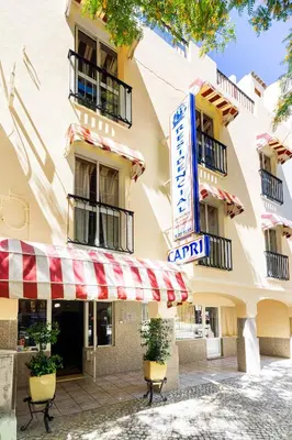 a building with a cafe sign in front of it at Residencial Capri by Umbral in Albufeira