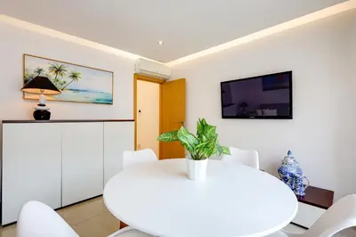a white dining room with a white table and chairs at Casa Maguy in Albufeira