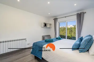 a bedroom with a large bed with a window at #239 Vivenda V3 com Piscina by Home Holidays in Albufeira