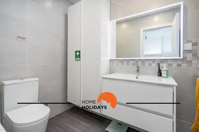 a bathroom with a toilet and a sink and a mirror at #239 Vivenda V3 com Piscina by Home Holidays in Albufeira