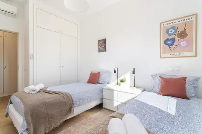 a bedroom with two beds and a mirror at Host Wise - Serene Spacious House - Swimming Pool & Garden in Olhos de Água