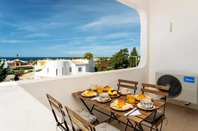 a table with food on a balcony with a view at Host Wise - Bright Lovely Flat - Balcony in Guia