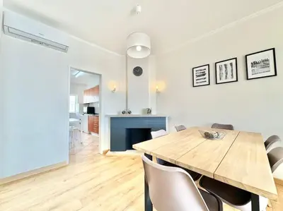 a dining room with a table and a fireplace at Sea Front 180º View with AC and WiFi in Quarteira
