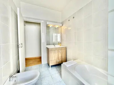 a white bathroom with a tub and a sink at Sea Front 180º View with AC and WiFi in Quarteira