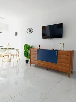a living room with a television on top of a cabinet at Casa Patricia in Albufeira