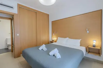 a bedroom with a bed with a lamp on it at #251 Coronel Águas by Home Holidays in Albufeira