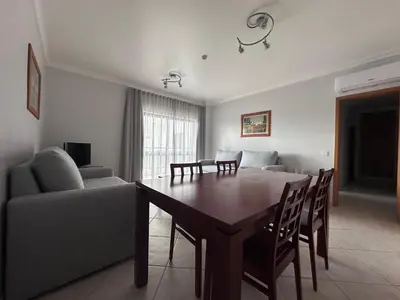 a living room with a table and a couch at Oceanview Bliss in Albufeira Retreat Over Oldtown in Albufeira
