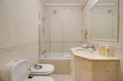 a bathroom with a toilet and a sink and a shower at Cozy Apt 5min Beach Ocean View AC Wi Fi in Albufeira