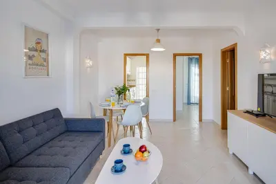 a living room with a couch and a table at Cozy Apt 5min Beach Ocean View AC Wi Fi in Albufeira