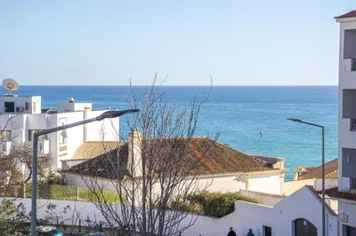 a view of the ocean from a city with buildings at Cozy Apt 5min Beach Ocean View AC Wi Fi in Albufeira
