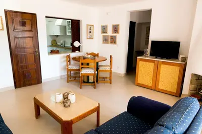 a living room with a couch and a table at The Albufeira Concierge - Villa Praia São Rafael in Albufeira