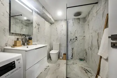 a bathroom with a toilet and a sink and a shower at Alcaçarias Suite 20 in Faro
