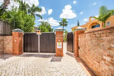 a gate to a house with a brick fence at Villa Norcas Grande in Galé