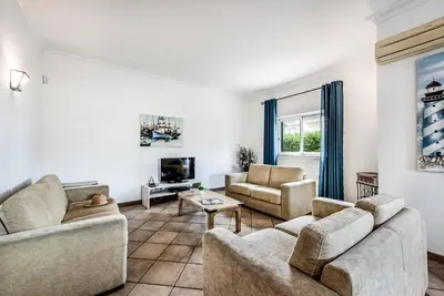 a living room with two couches and a tv at Villa Norcas Grande in Galé