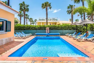 a swimming pool with lounge chairs and a resort at Villa Norcas Grande in Galé