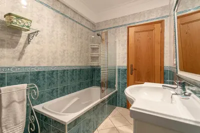 a bathroom with a tub and a sink at Host Wise - Wonderful Flats with Pool in Albufeira