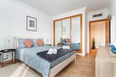 a bedroom with a bed with two shoes on it at Host Wise - Wonderful Flats with Pool in Albufeira