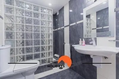 a bathroom with a sink and a toilet and a mirror at #248 Villa Loureira 54 by Home Holidays in Albufeira