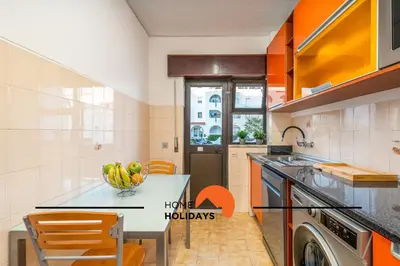 a kitchen with a table with a bowl of fruit on it at #252 Bartolomeu Dias 7 by Home Holidays in Albufeira