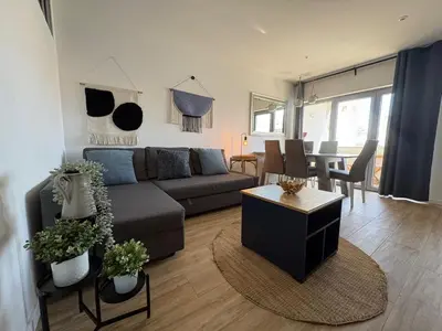 a living room with a gray couch and blue pillows at TAC - Blue Horizon Albufeira in Albufeira