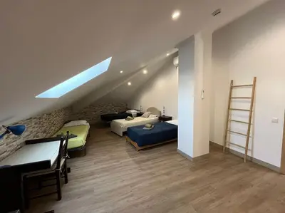 a attic room with two beds and a ladder at Castle House Loulé City Center in Loulé