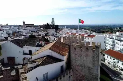a city with a flag on top of a building at Castle House Loulé City Center in Loulé